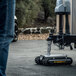 A man using a remote-controlled Trailer Valet RVR5 robot to move a trailer.