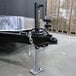 A Trailer Valet JX tongue jack on a trailer hitch with a chain around it.