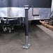 A black Trailer Valet tongue jack with a metal pole attached to it.