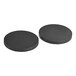 A pair of black round rubber pads.