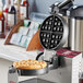 A waffle maker with a Belgian waffle plate inside.