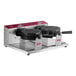 An Estella commercial double waffle maker with black and red covers and handles.