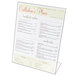 A Cal-Mil clear acrylic Easel Displayette with a menu on a stand.