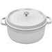 A white enamel coated GET Heiss round dutch oven with a lid.