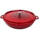 A red round brazier with a lid on a table.