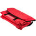 A red Rubbermaid insulated delivery bag with a black strap.