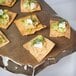 A GET melamine display tray with crackers, cucumber, and cream cheese on top.