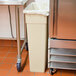 A beige rectangular Continental wall hugger trash can.