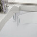 A close-up of a white Turbo Air ice cream dipping cabinet with a clear plastic cover.