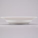 A white bowl on a grey surface.