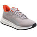 A pair of grey Reebok athletic shoes with orange accents.