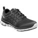 A black shoe with white accents and a white sole.