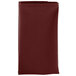 A folded burgundy Intedge cloth napkin.