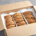 A box of Best Maid Thaw and Serve Chocolate Chip Cookies with M&M's on a counter.