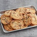 A tray of Best Maid Chocolate Chunk Cookies on a metal surface.