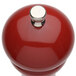 A Chef Specialties candy apple red pepper mill with a silver knob.