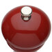A Chef Specialties red pepper mill with a silver top.