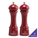 A Chef Specialties red pepper mill and salt mill set on a table.