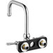 A Chicago Faucets wall-mounted faucet with two brass handles.