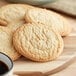 Best Maid thaw and serve sugar cookies on a plate with a cup of coffee.