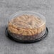 A Hahn's Bakery Raspberry German Crumb Cake in a plastic container on a table in a bakery display.