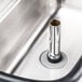 A stainless steel metal pipe in a sink.