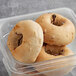 A plastic container with a Greater Knead Gluten-Free Cinnamon Raisin bagel inside.