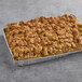 A half sheet tray of Hahn's Bakery caramel apple German crumb cake on a table.