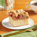 A piece of Hahn's Bakery Raspberry German Crumb Cake on a plate with crumble topping.