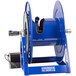A blue metal Coxreels hose reel with a black motor.