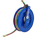 A blue Coxreels hose reel with green and red hoses.