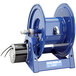 A blue Coxreels 1125PCL Series power cord reel with a metal handle.