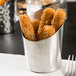 An American Metalcraft stainless steel cup filled with fried food.