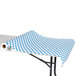 A white table with a blue and white polka dot paper table cover on it.