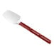 A red Vollrath SoftSpoon Silicone Spoonula with a white handle.