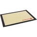 A black and tan de Buyer silicone baking mat with red text reading "de Buyer" on it.