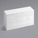 A stack of Tork white multi-fold paper towels.