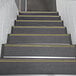 A set of stairs with black and yellow striped Wooster Stairmaster treads.