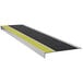 A Wooster Flexmaster stair tread with black and yellow grit and a yellow stripe on a white background.