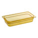 A Carlisle amber rectangular plastic food pan on a counter.