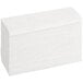 A stack of Tork white multi-fold paper towels.