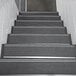 A close-up of a black and white staircase with Wooster black stair treads.