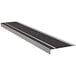 A close-up of a Wooster Flexmaster Stair Tread with black and silver grit surface.