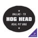 A black and white rectangular vinyl wall sticker with white text that says "Dallas Texas Hog Head Real Pit Bull" on a table.