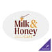 A white oval Carnival King sticker with brown text that says "milk and honey cafe"