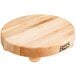 A John Boos round maple wood cutting board with bun feet.