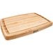 A John Boos maple wood cutting board with grooves on it.