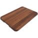 A John Boos black walnut wood cutting board with finger grips.