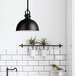 A black Canarm Polo pendant light over a white sink.