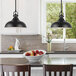 A kitchen with two Canarm Sussex black classic LED pendant lights over a counter.